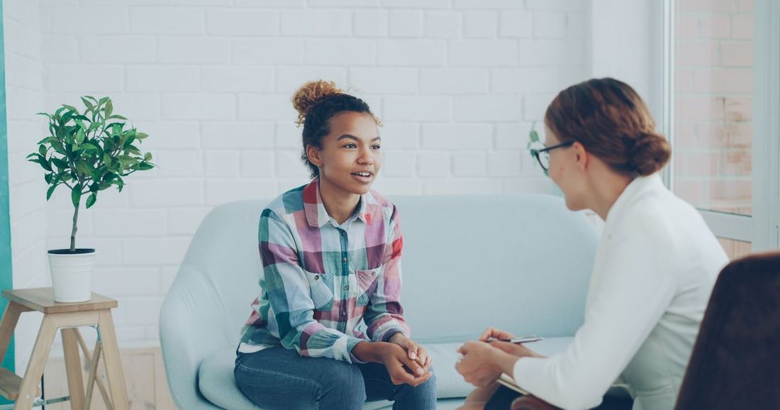 A teenage girl talking with a counselor
