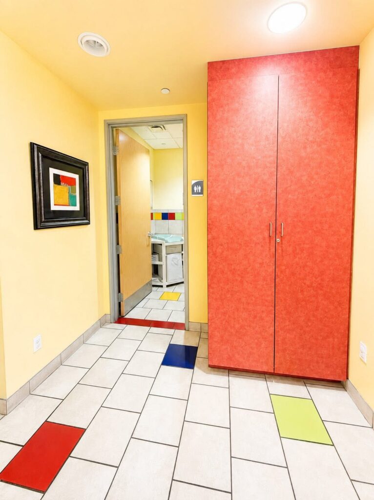 A hallway corner with a red cabinet