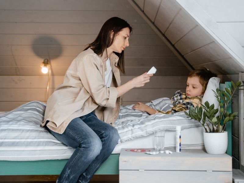 A parent checking a child's temperature